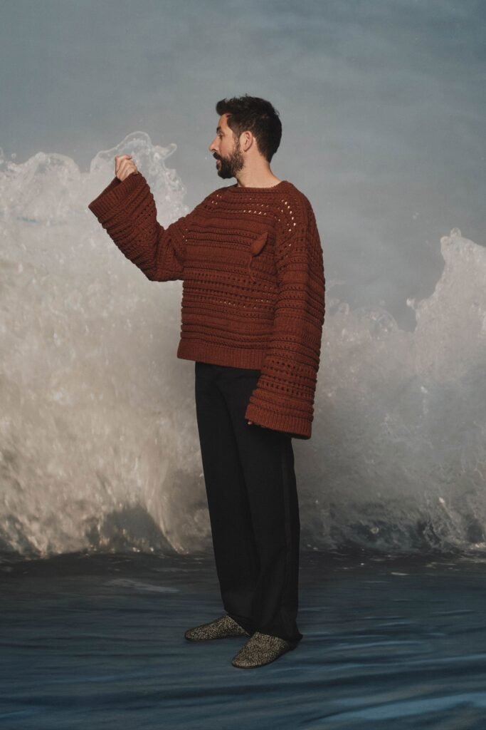 Image may contain Clothing Knitwear Sweater Adult and Person